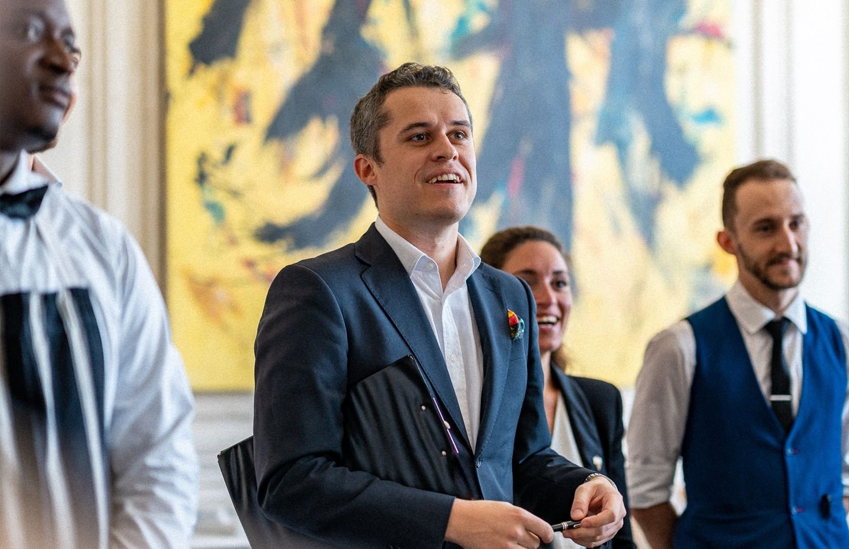 People standing and smiling - LPM Doha